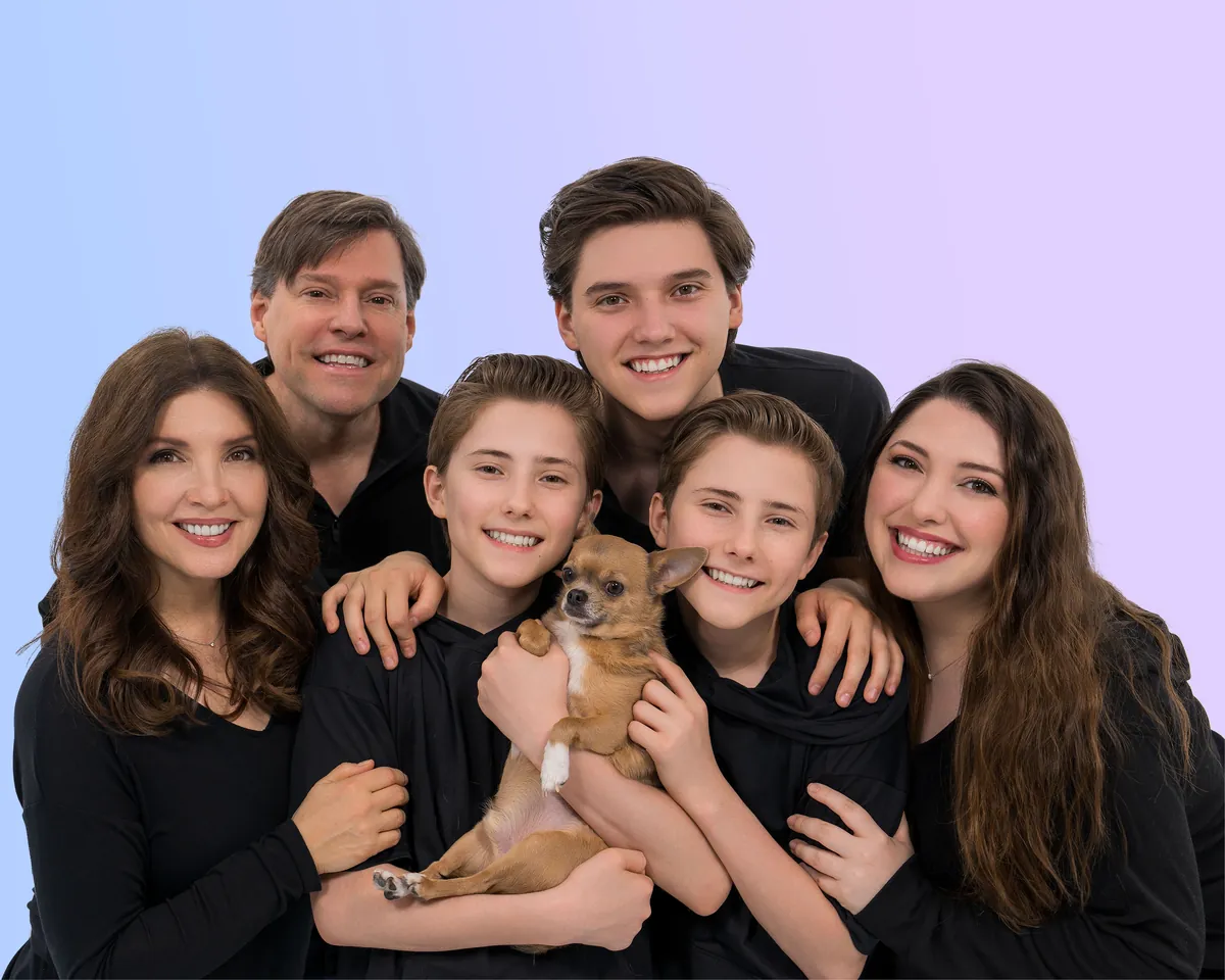 The Sharpe family close together in black, with their dog Chewy