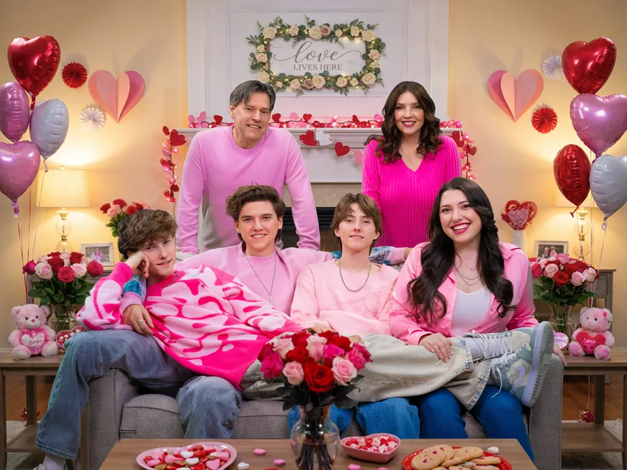 The six Sharpe Family Singers laughing together in matching pink outfits