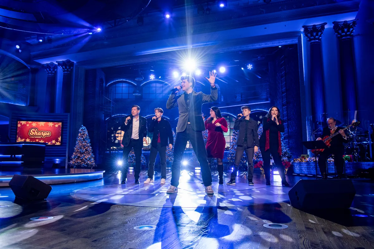 A Sharpe Family Singers lead vocal at the front of the stage